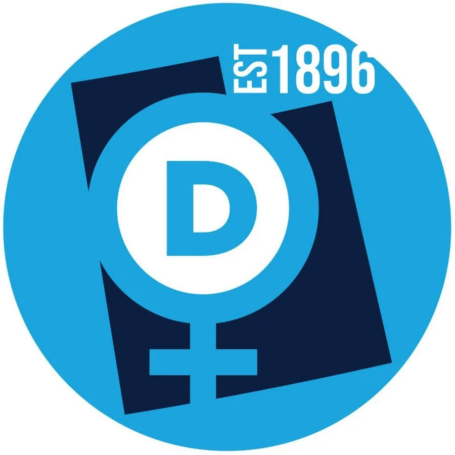 Logo with a blue background, a white circle with a blue 'D', and black gender symbols, with text 'EST 1896'.