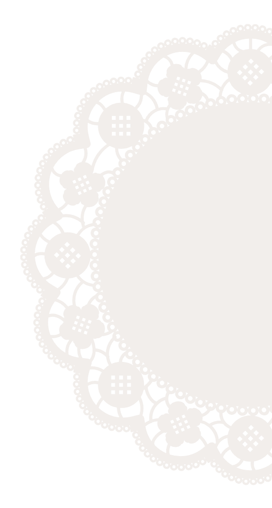 A white lace doily with a floral pattern on a black background, oval shape with a large central empty space.