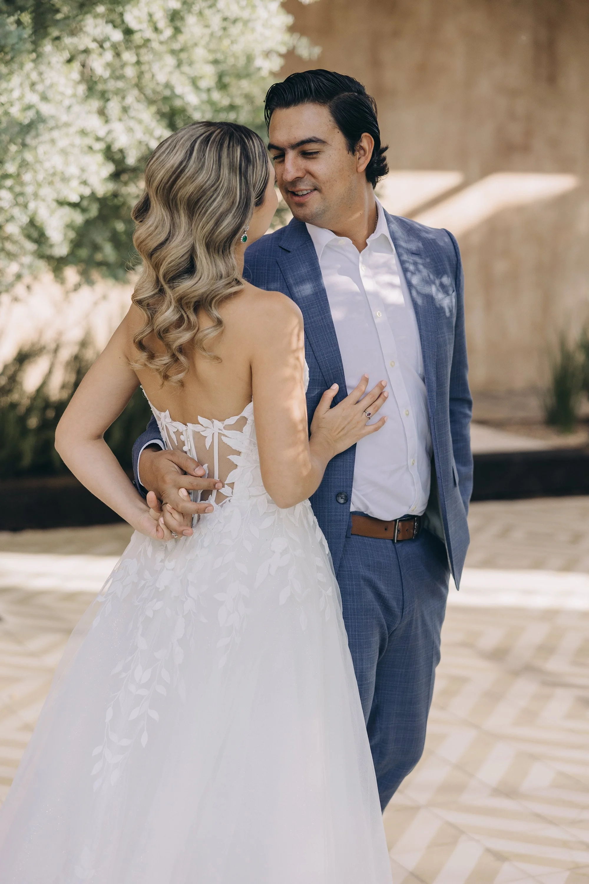 Newlywed couple sharing a romantic moment in a lush tropical wedding setting in Puerto Rico