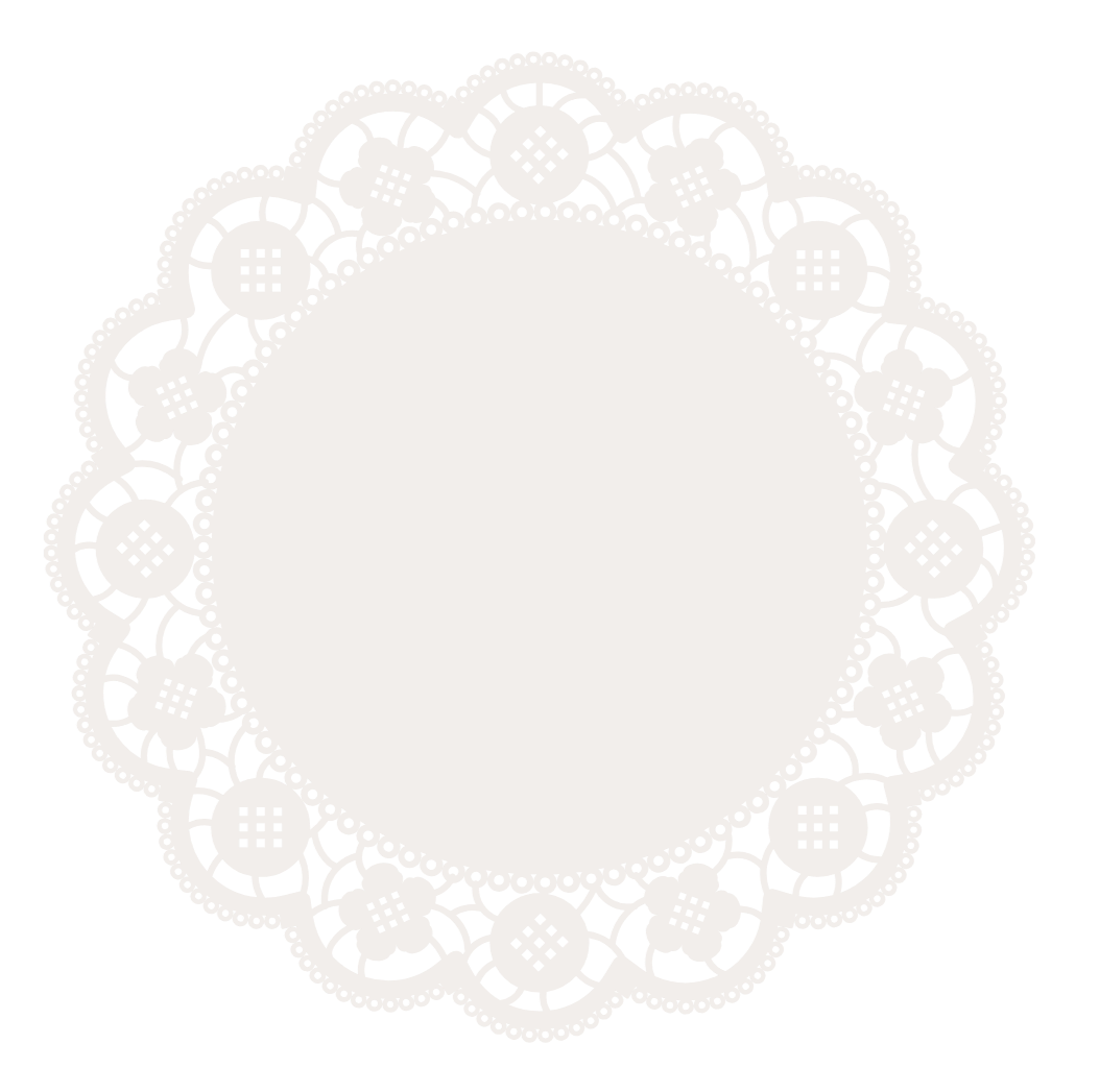 A white paper doily with intricate lace-like patterns on a black background.