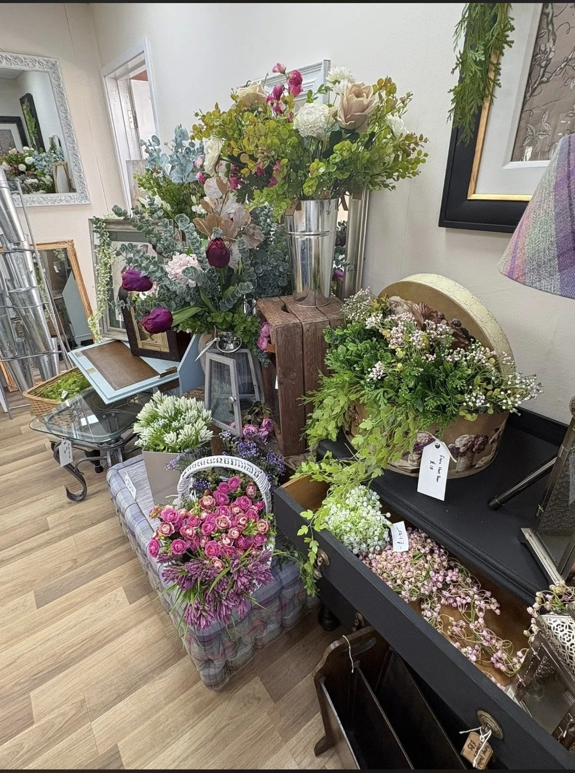 Display of various fresh floral arrangements and bouquets in a flower shop.