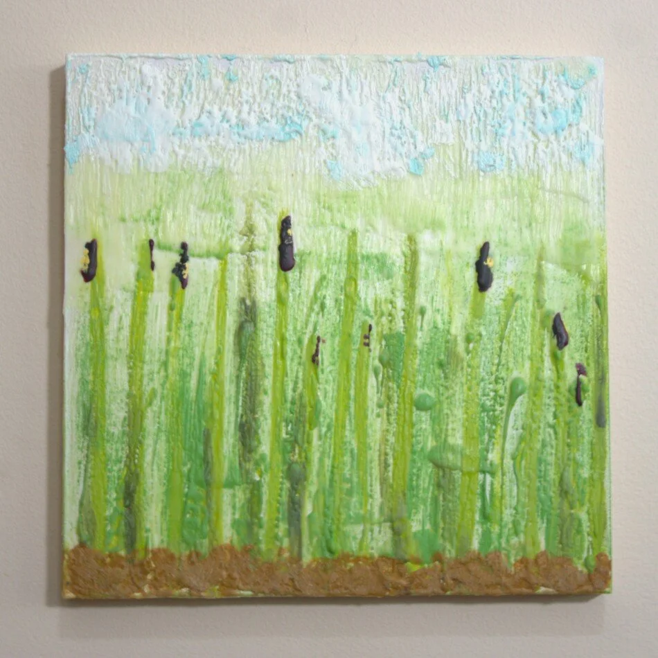 green and purple landscape of irises in an encaustic mixed media painting