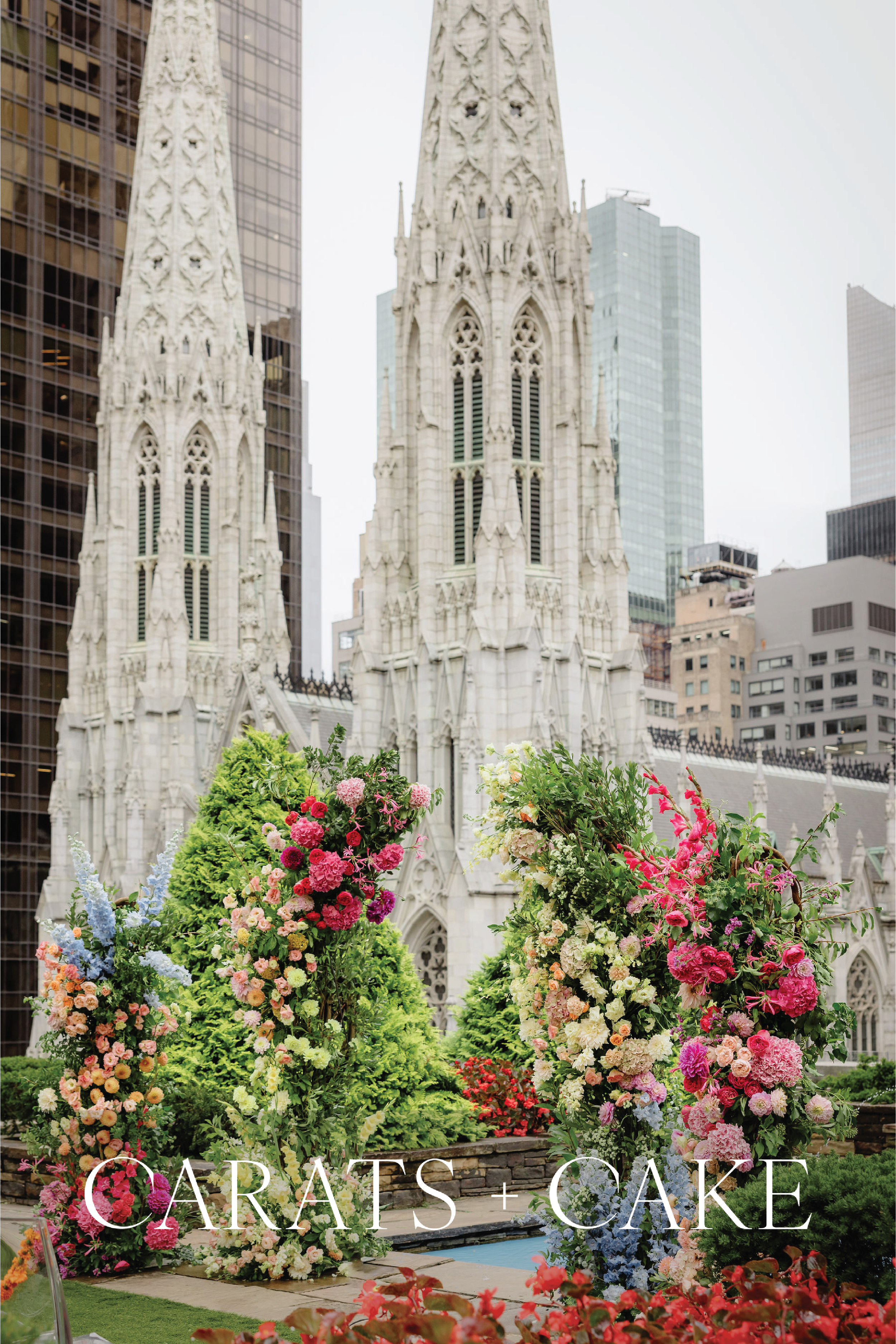Colorful floral arrangements in front of St. Patrick's Cathedral in New York City with the words 'CARA TES + CAKE' overlaid.