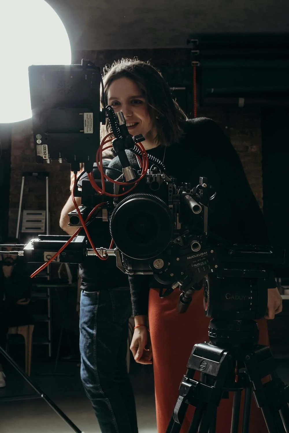 female director looking into viewing screen to see if the shot was captured for the movie
