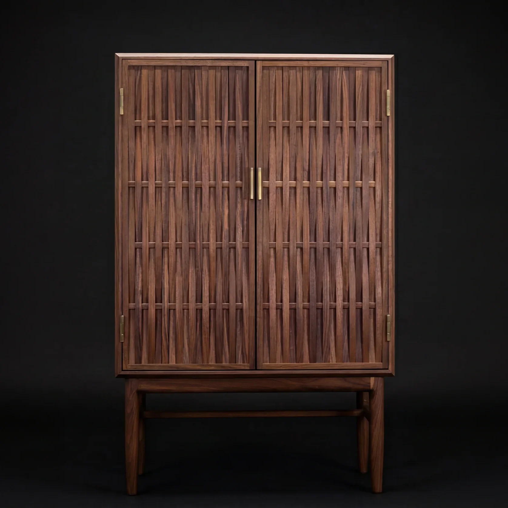 A wooden cabinet with slatted doors on a black background.