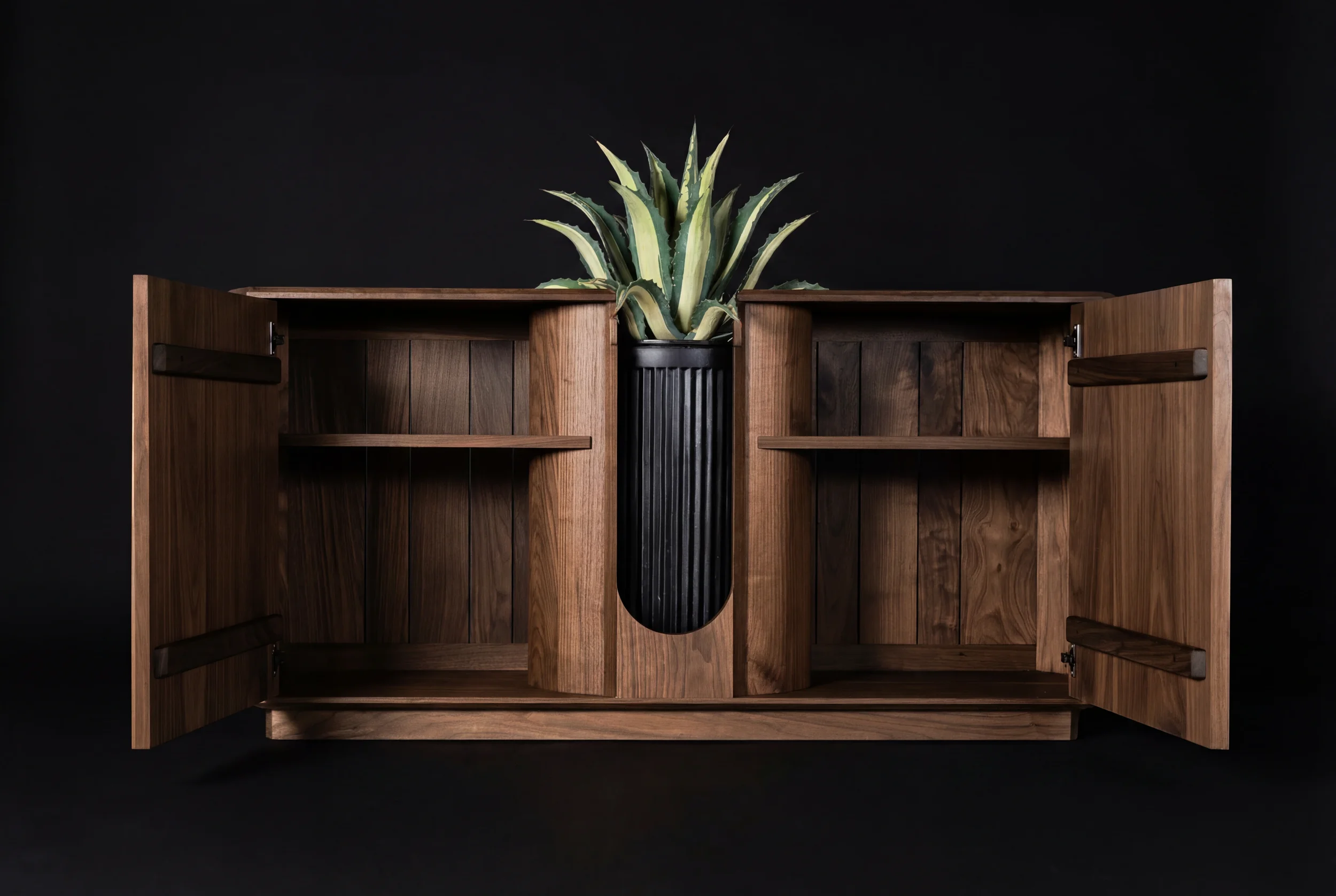 Open wooden cabinet with plants inside, set against a black background.