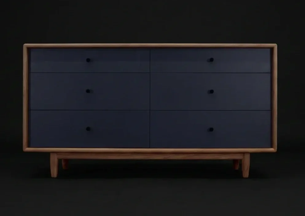 A modern wooden dresser with six dark blue drawers and black knobs, set against a black background.