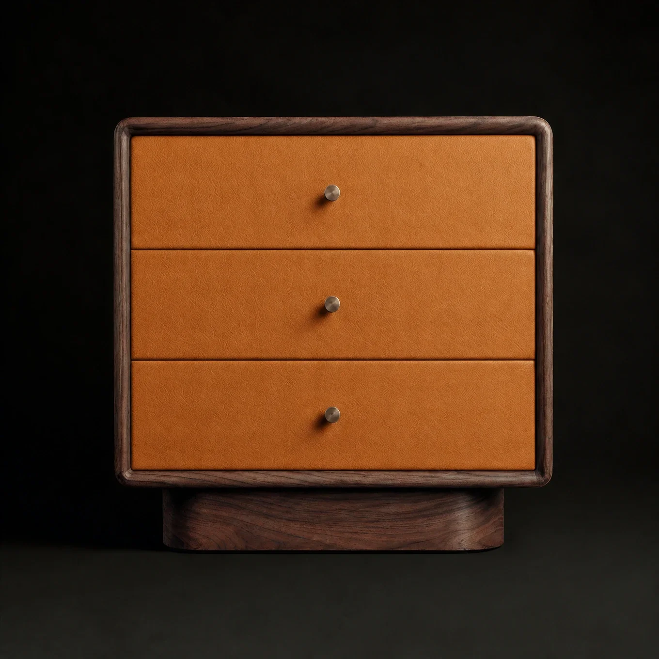 A wooden drawer unit with three drawers, each with a small round metal knob, set against a black background.