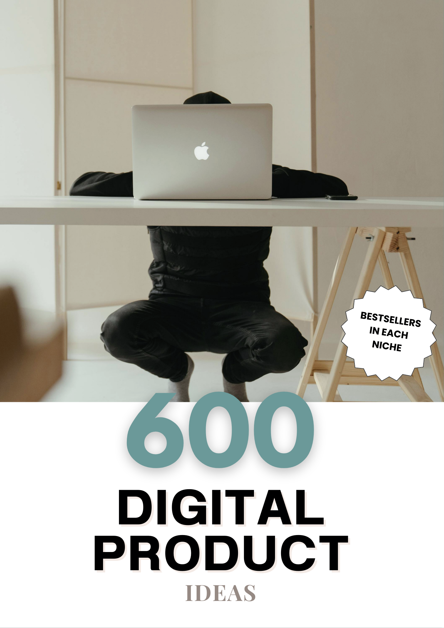 A person wearing a black jacket and gray socks sitting at a white desk with an open MacBook, with a wooden easel in the background and a sticker stating "Bestsellers in Each Niche".