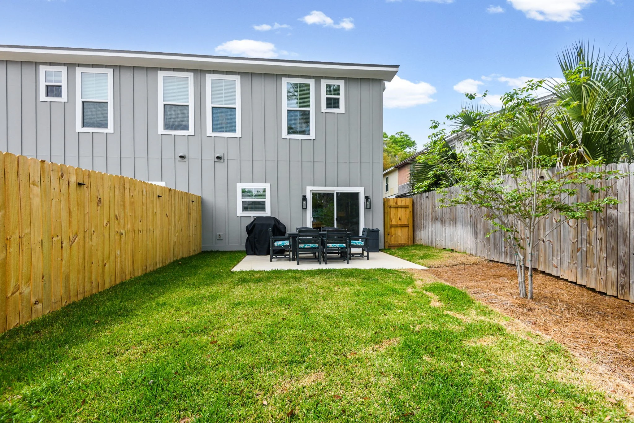 Fenced Back Yard with Patio Table & Gas Grill