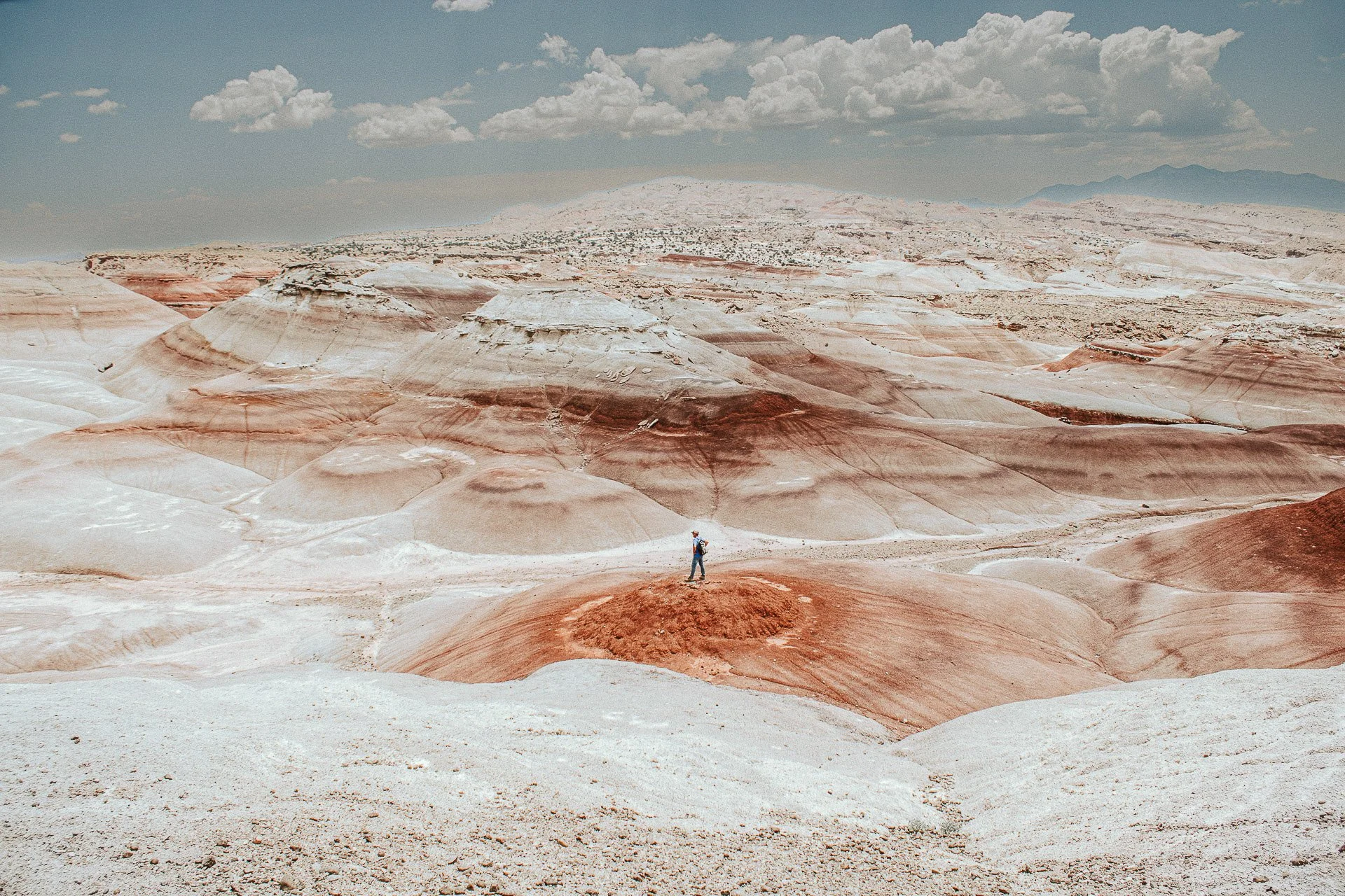 Wanderer on Mars. A person walking on the colorful, Mars-like, red dunes of Bentonite Hills, Utah.