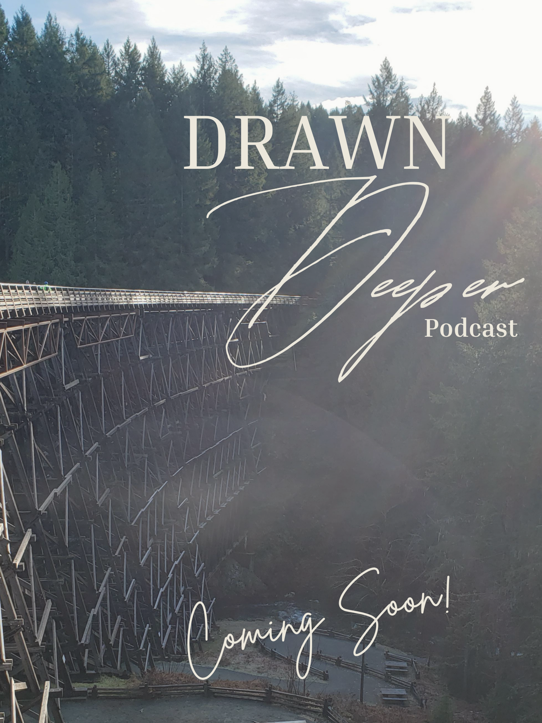 An old trestle bridge  across a river in a forested area with trees and cloudy sky in the background, with overlaid text saying "DRAWN Deeper Podcast Coming Soon!".