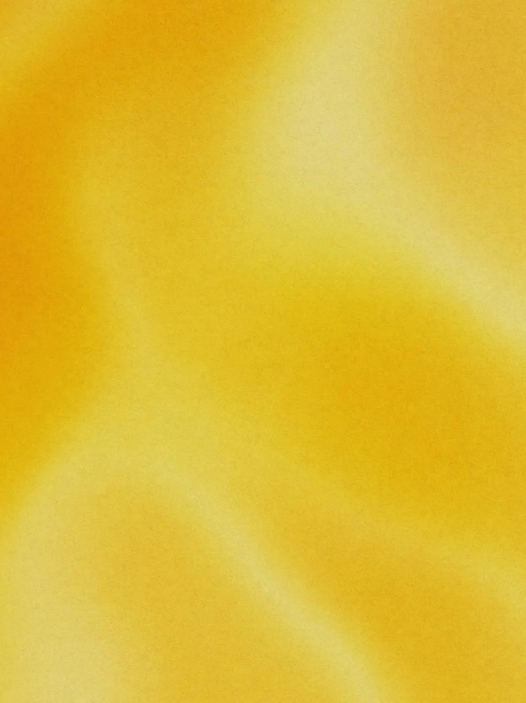 Close-up of a yellow surface with some indistinct light and shadow variations.