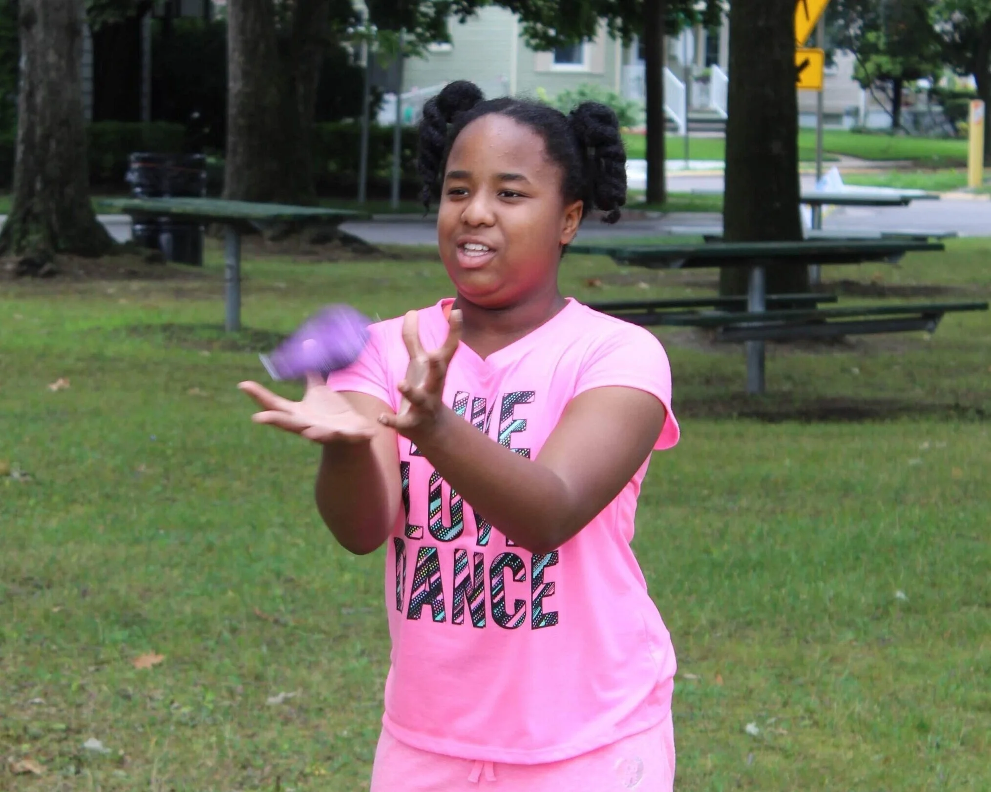 A GUTs camper catching a water balloon.