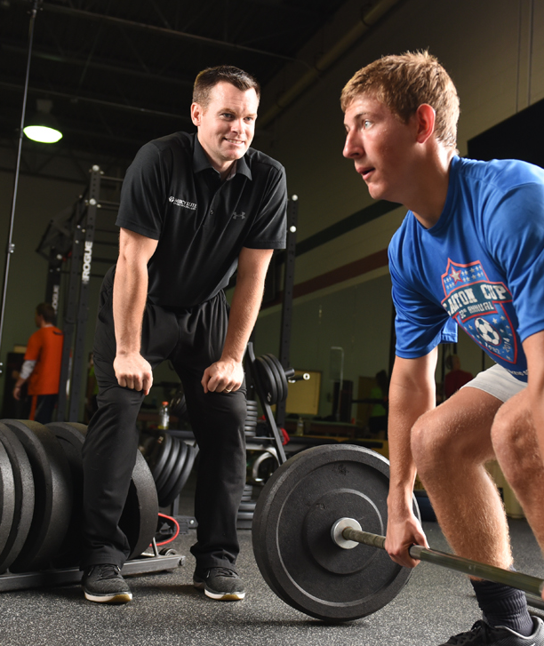 Dan Wolocko training a weightlifter.