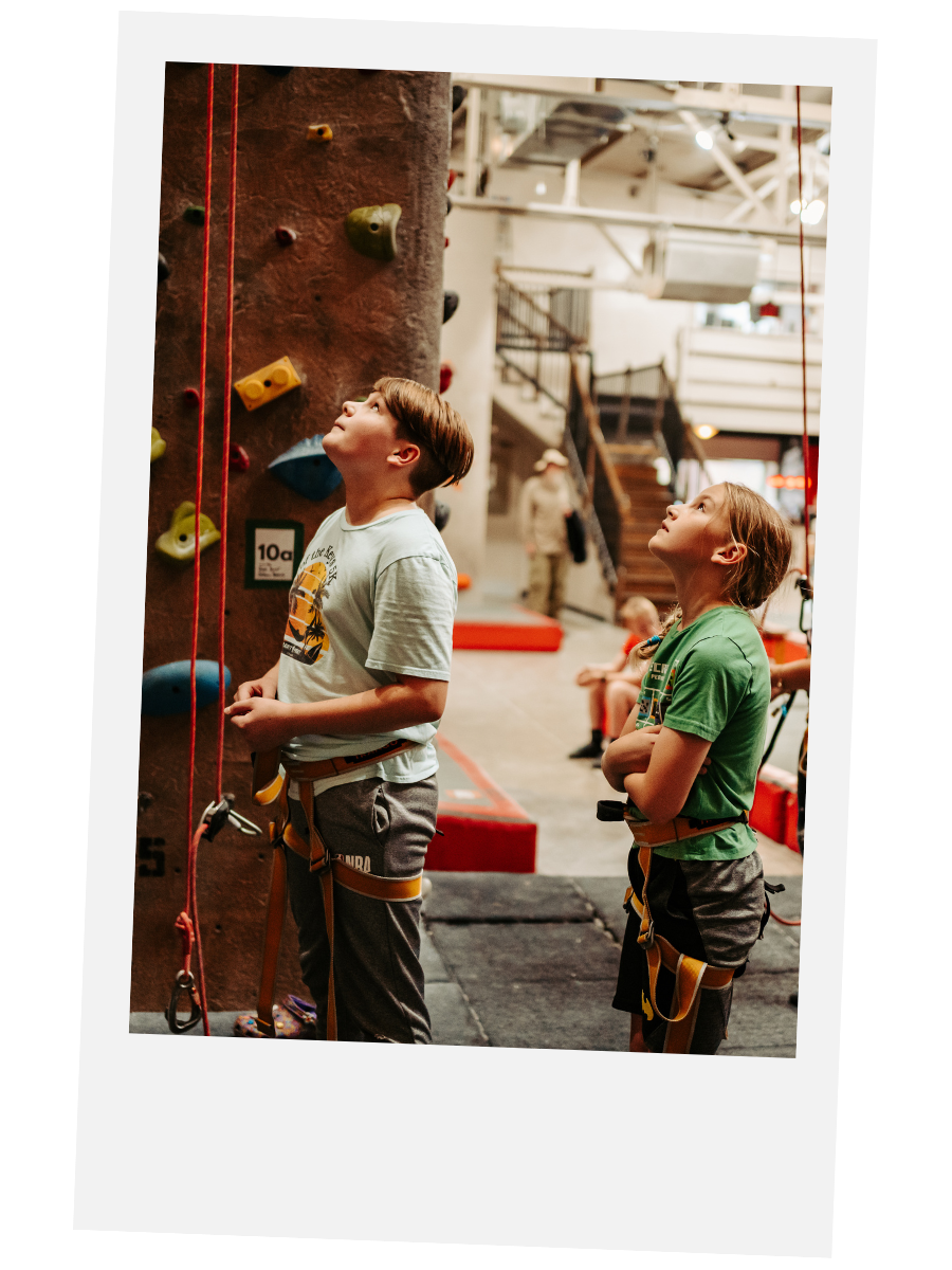 Two boys watching other people climbing