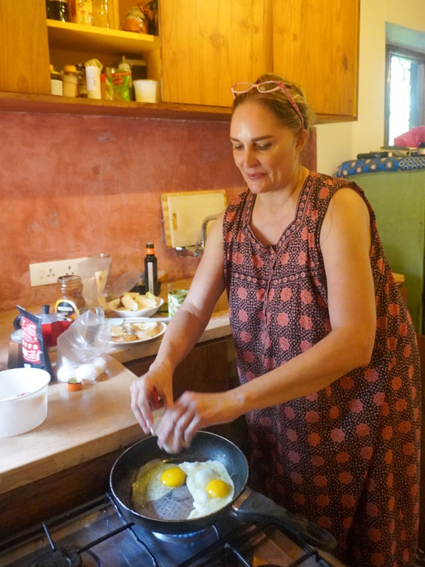   Mom cooks breakfast in the kitchen designed by the Olio team!  