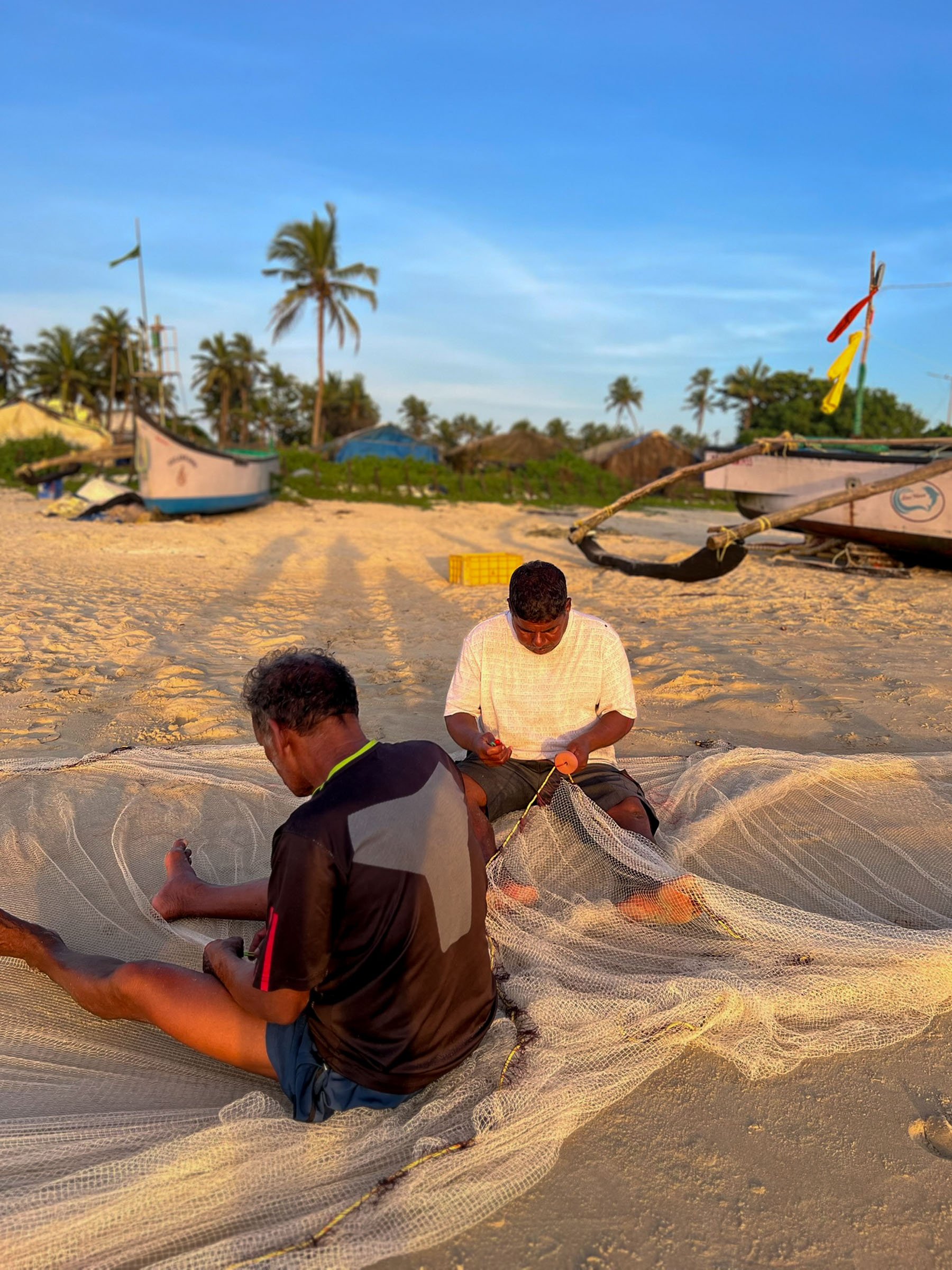   Post-tennis swim looked something like this (fisherman patching their nets after a long day)  