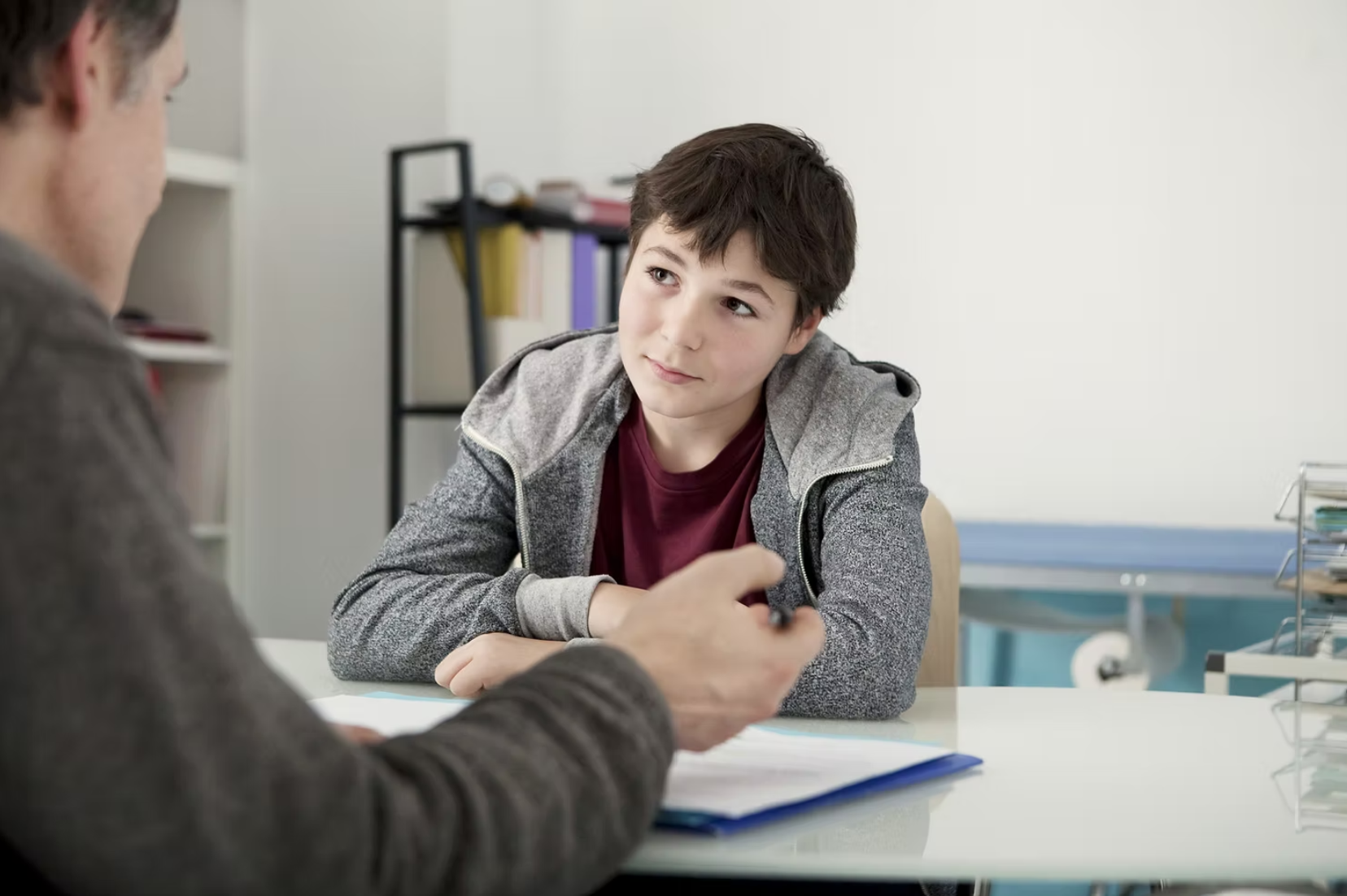 child sitting at a table in school