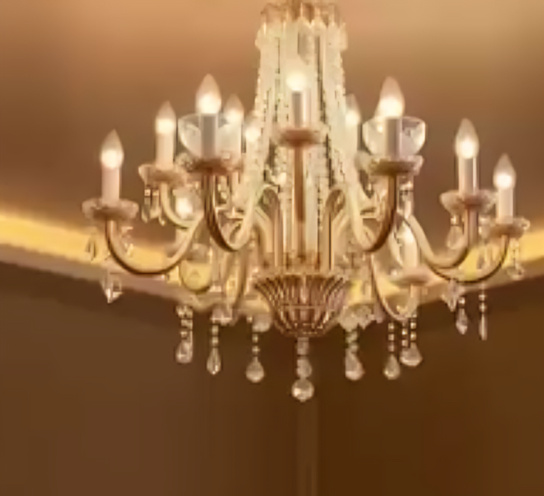 A large ornate chandelier with multiple candle-like lights hanging from a ceiling.