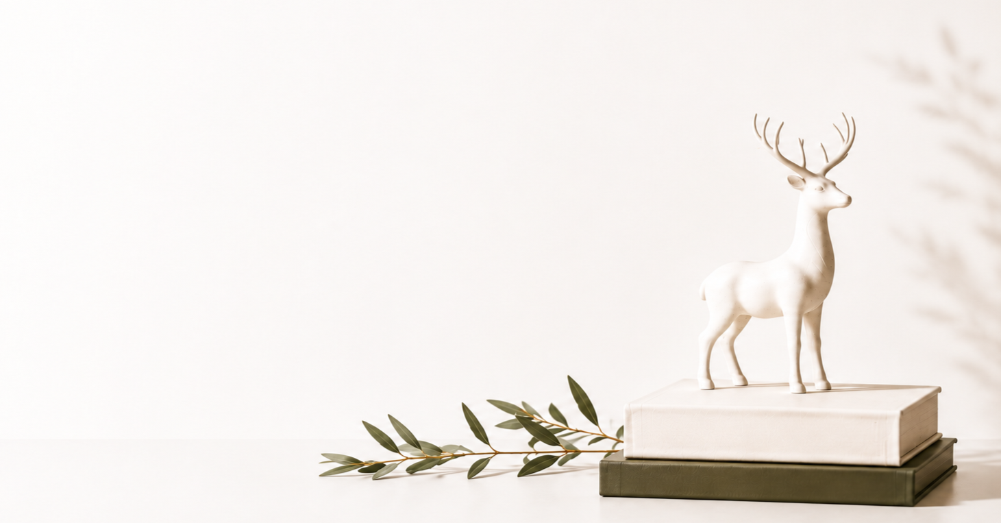 White reindeer sculpture on stacked books representing StandOut Leadership Consultancy executive services.