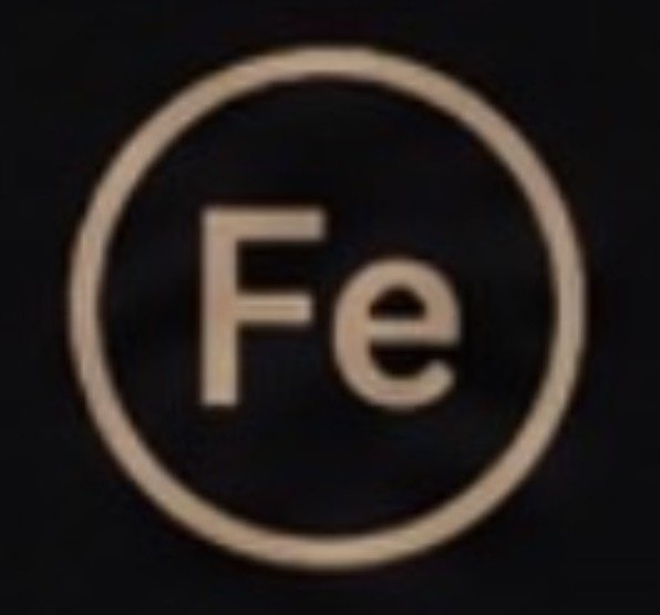 Close-up of a circular icon with the chemical symbol 'Fe' in the center, representing iron.