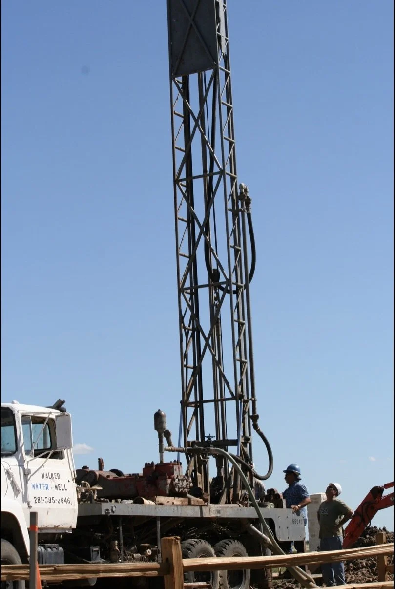 Water well drilling rig installing a residential well system