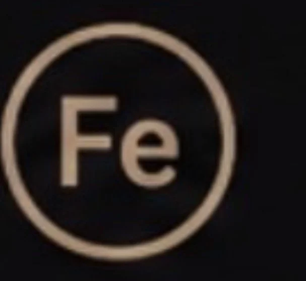Chemical element symbol for Iron (Fe) inside a circle.