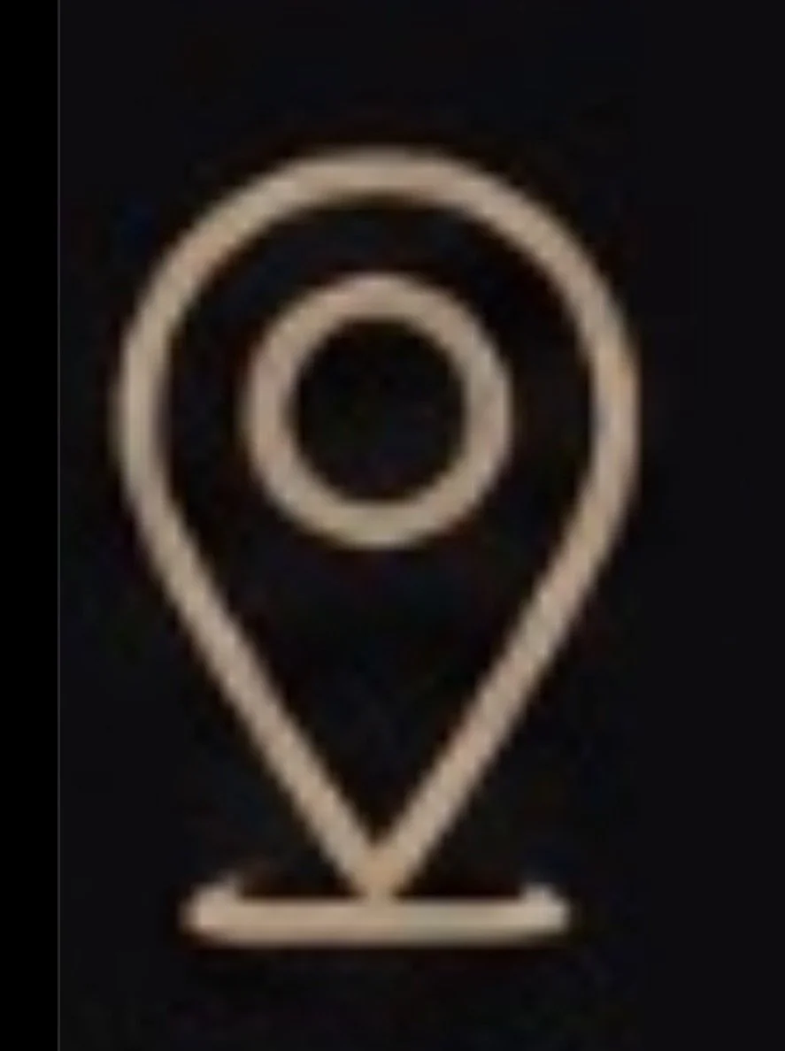 A neon sign or logo with a pin or location marker symbol featuring concentric circles inside a teardrop shape.