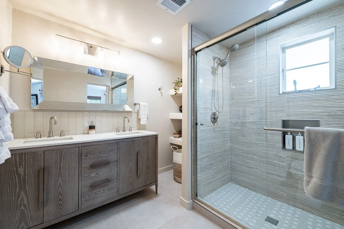 bathroom-remodel-neutral-tile-wood-vanity.jpeg