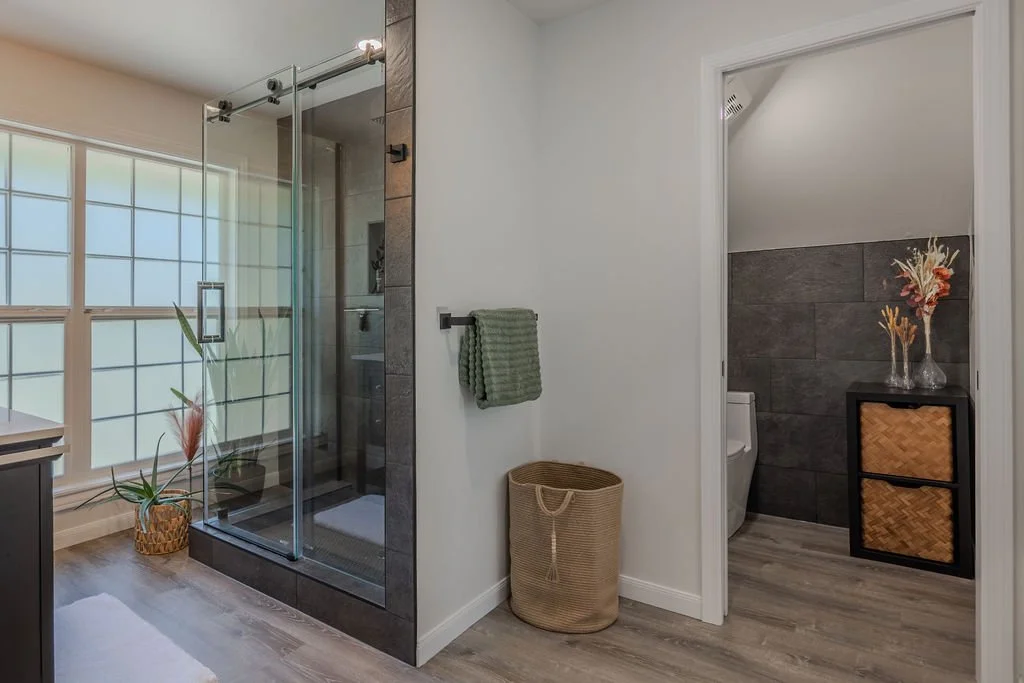 bathroom remodel with walk in shower, floor to ceiling tile and window with a separate w/c toilet room
