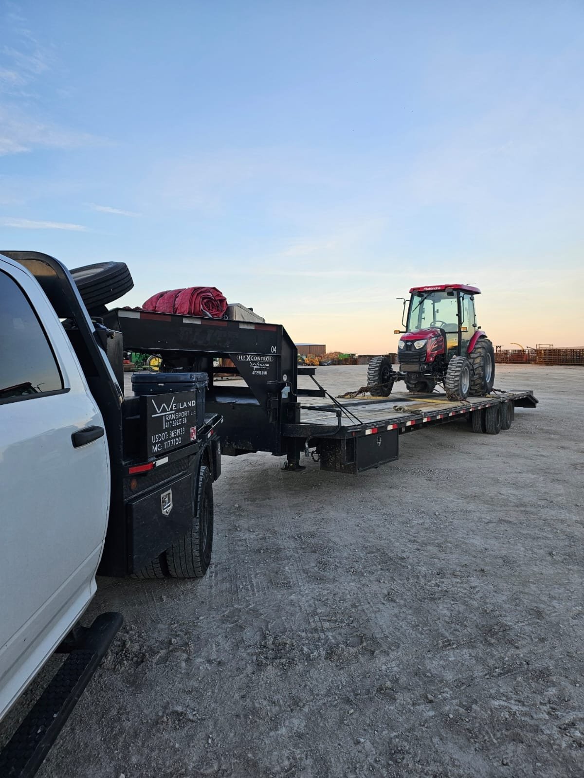 Semi truck hauling agricultural tractor on flatbed – Prime Load Solutions heavy haul USA