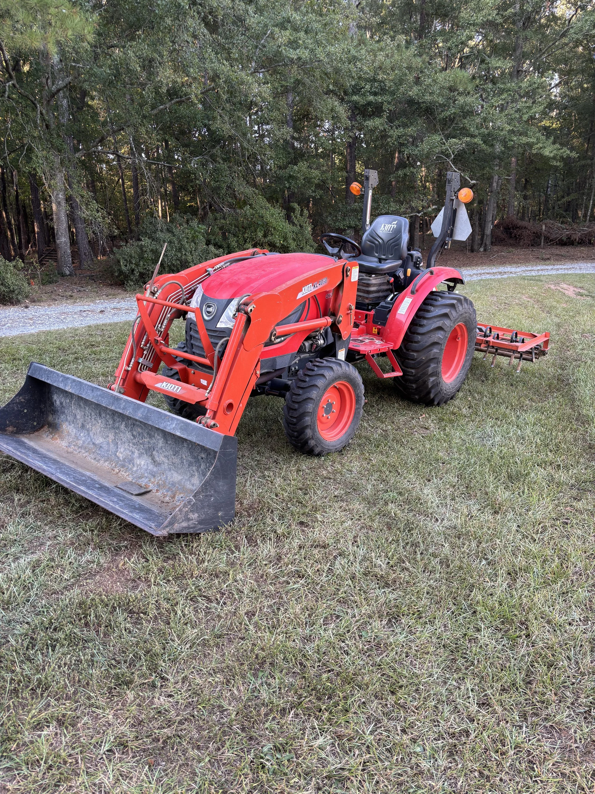 Red Kubota tractor transported by Prime Load Solutions LLC – heavy equipment hotshot delivery