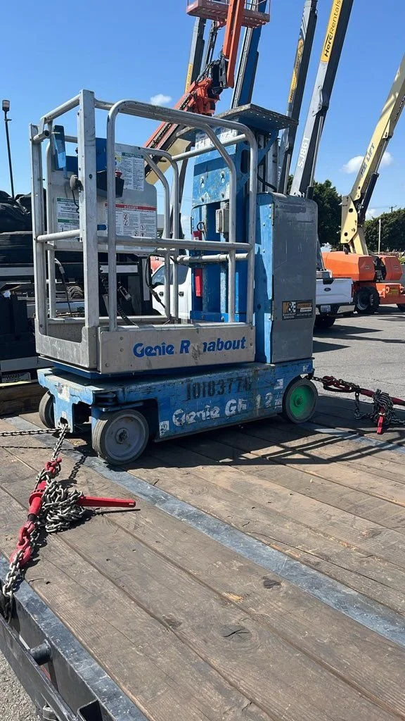 Genie boom lift loaded on flatbed trailer for transport – Prime Load Solutions heavy haul