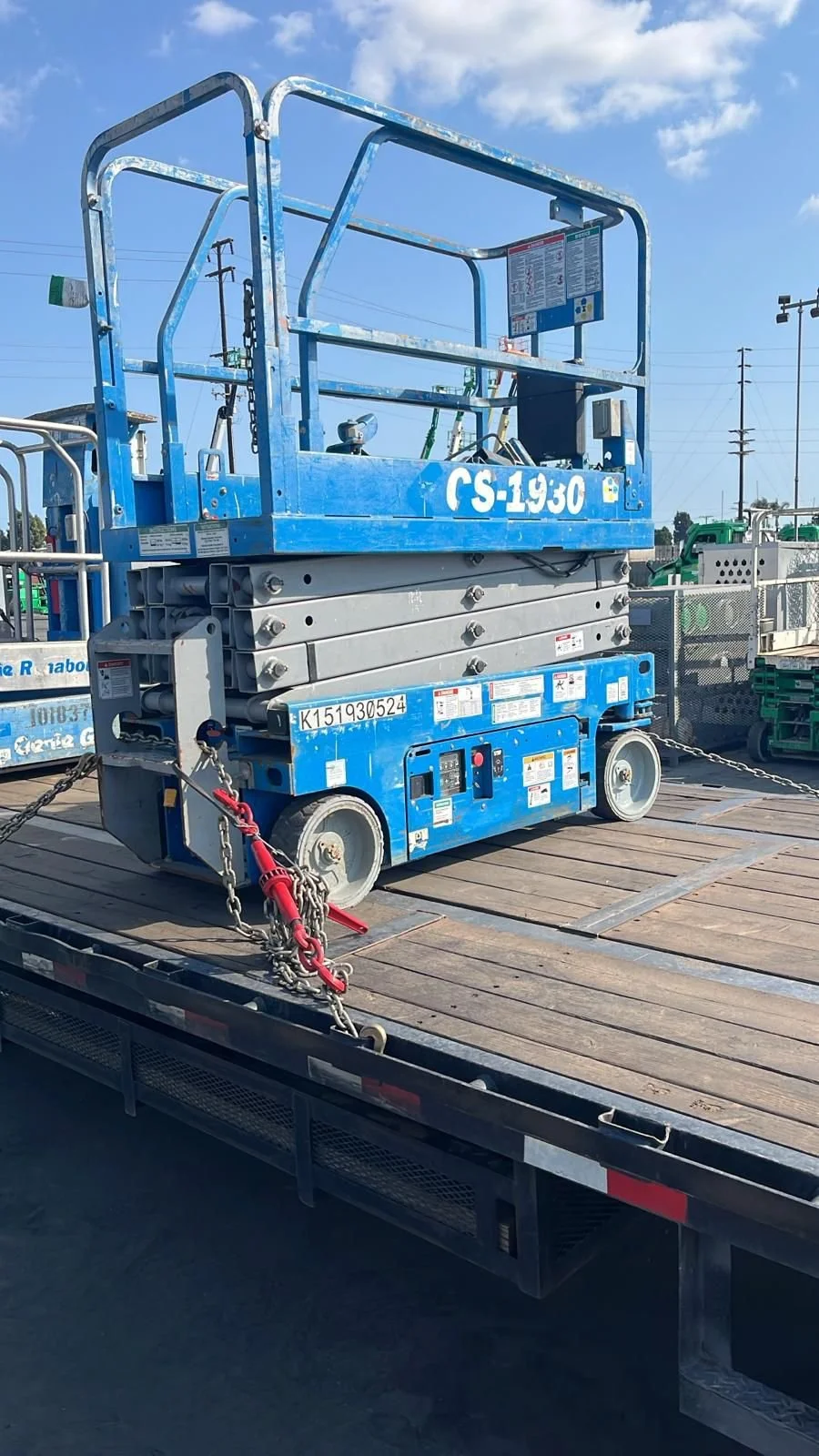 Blue aerial work platform secured on flatbed for oversize equipment transport – Prime Load Solutions