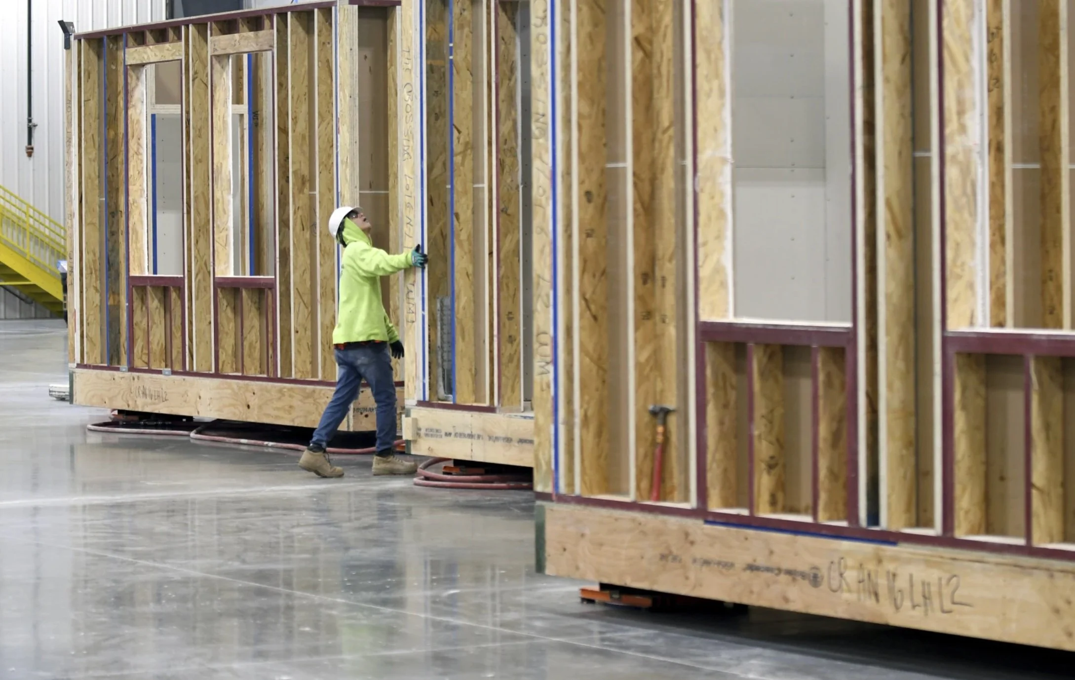 A worker inspects the framing of a modular home at the Fading West factory in Buena Vista, Colo., on Feb. 19, 2025. (AP Photo/Thomas Peipert)