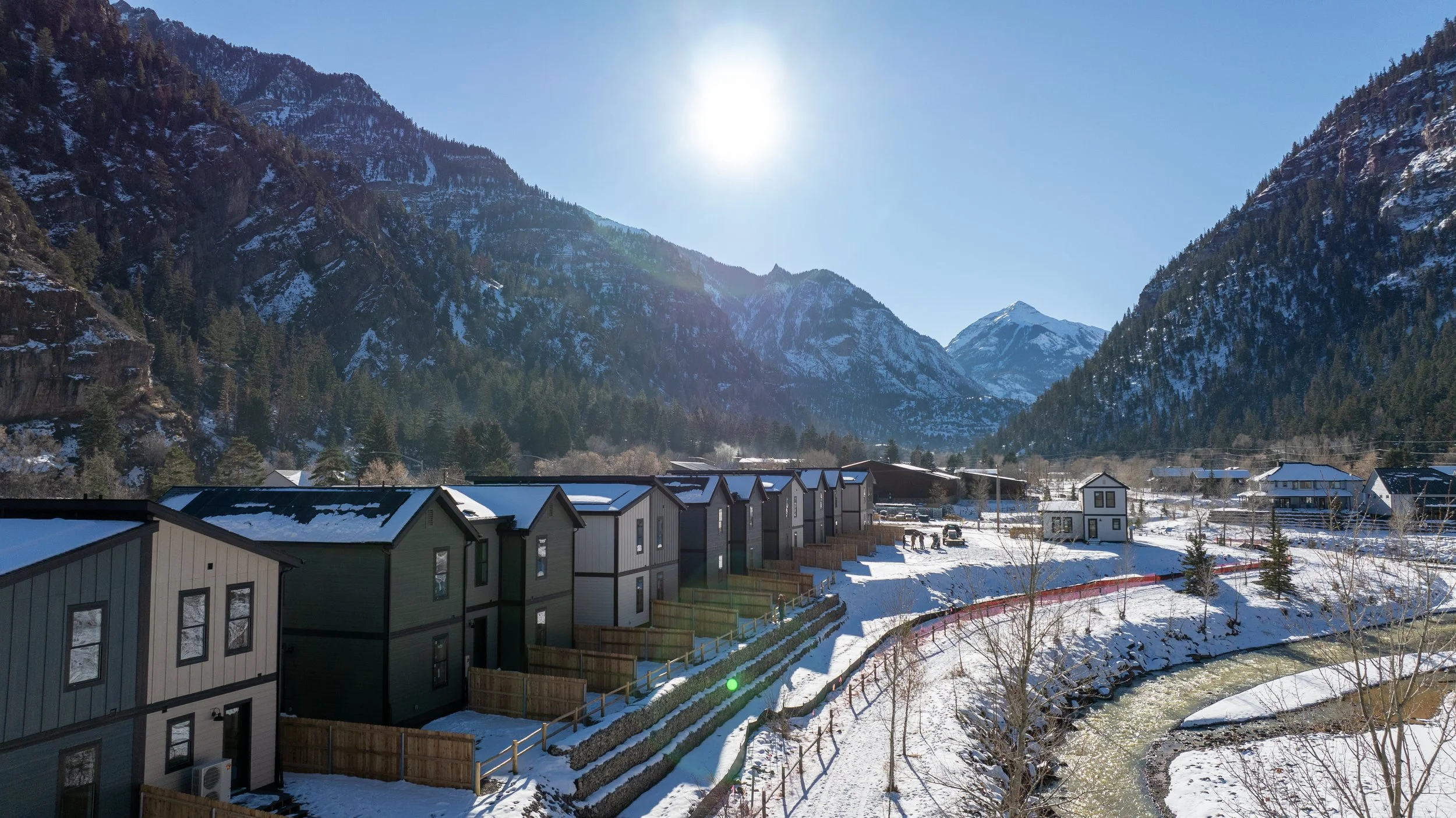 A snowy mountain landscape image featuring a workforce housing by Rural Homes and Fading West Development in Ouray, CO