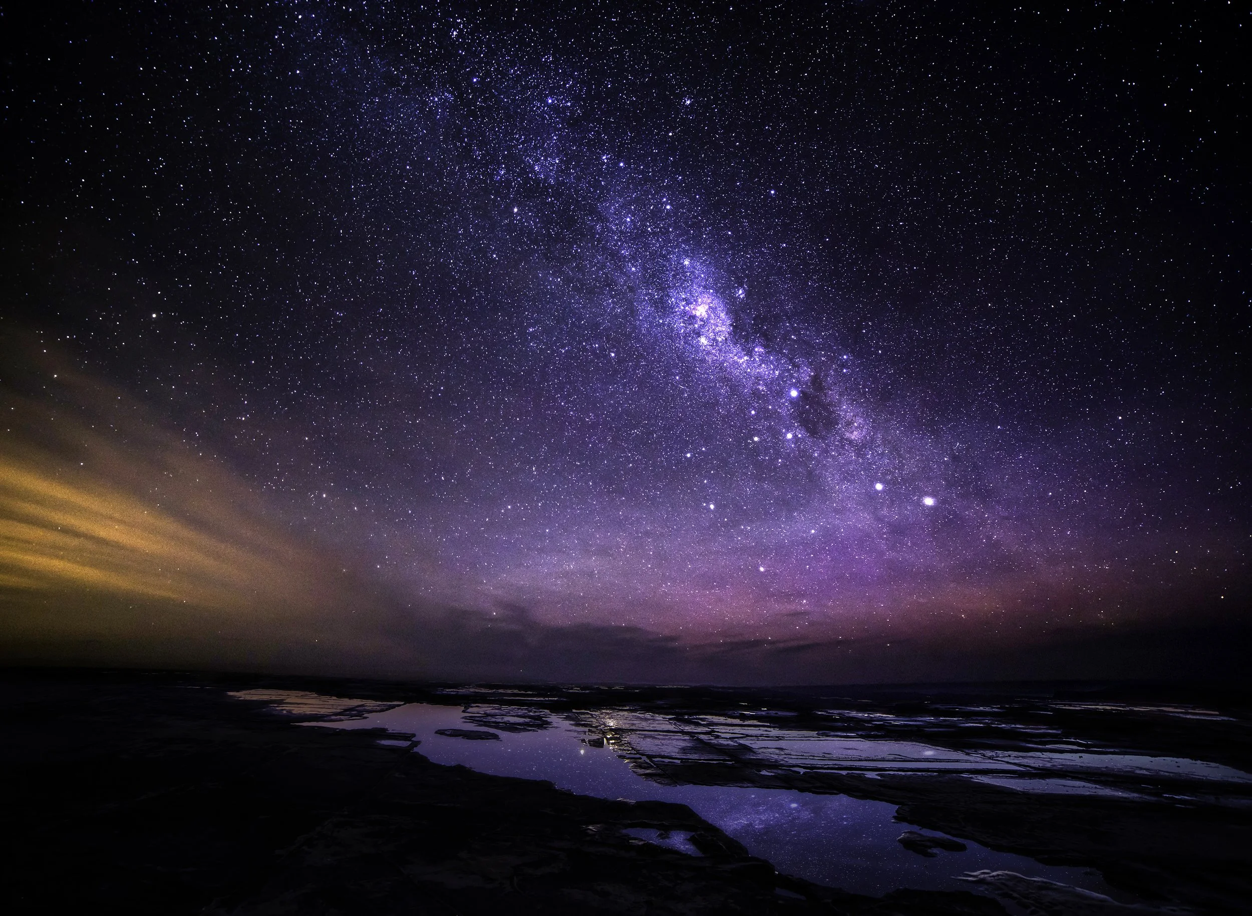 Night sky over tidal puddles