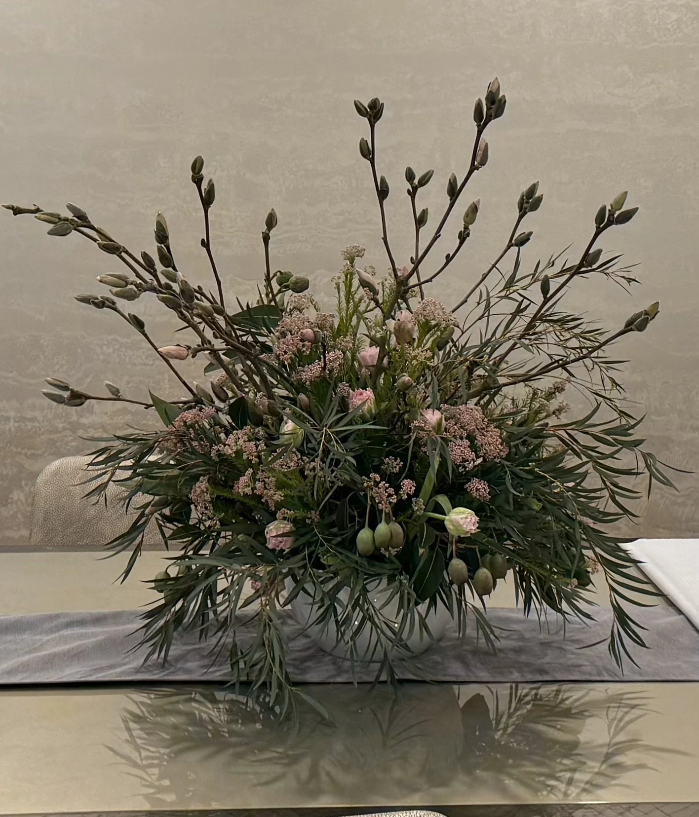 Large reception arrangement with Magnolia buds, Eucalyptus branches with pods, parrot tulips & rice flowers.