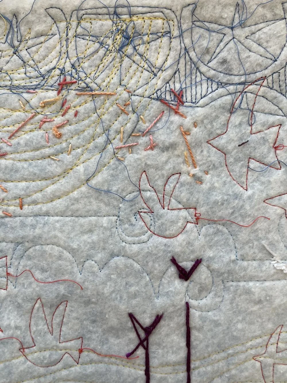 Close-up detail of hand-stitched embroidery, drawn shapes, and trailing threads from Deborah Boschert's Looking Up art quilt.