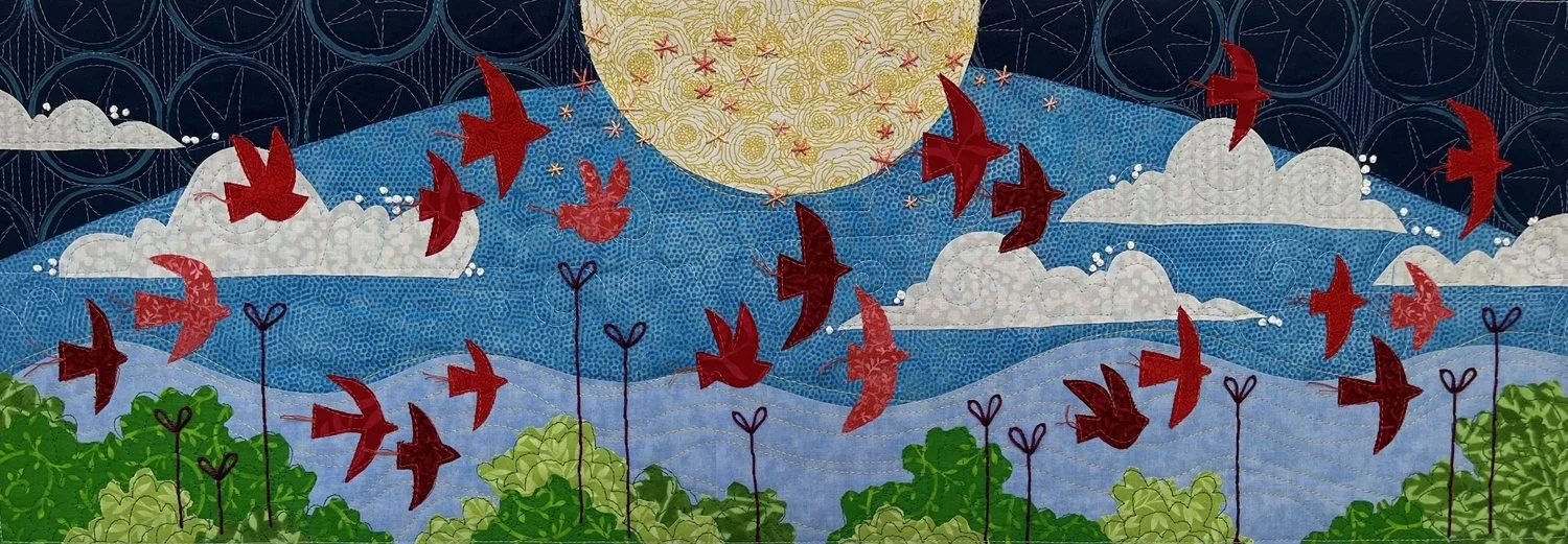 Looking Up, an art quilt by Deborah Boschert with red birds flying past a yellow moon over a blue sky, white clouds, and green landscape.