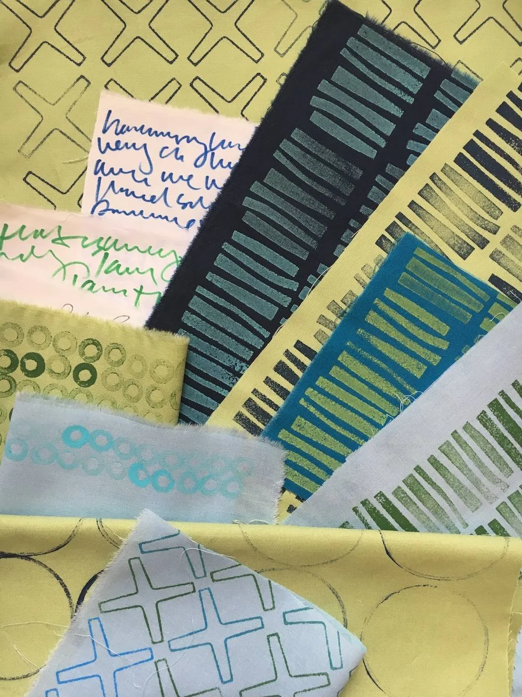 A collection of colorful washi tapes with various patterns, some with barcodes or geometric designs, and handwritten notes on small pieces of paper.