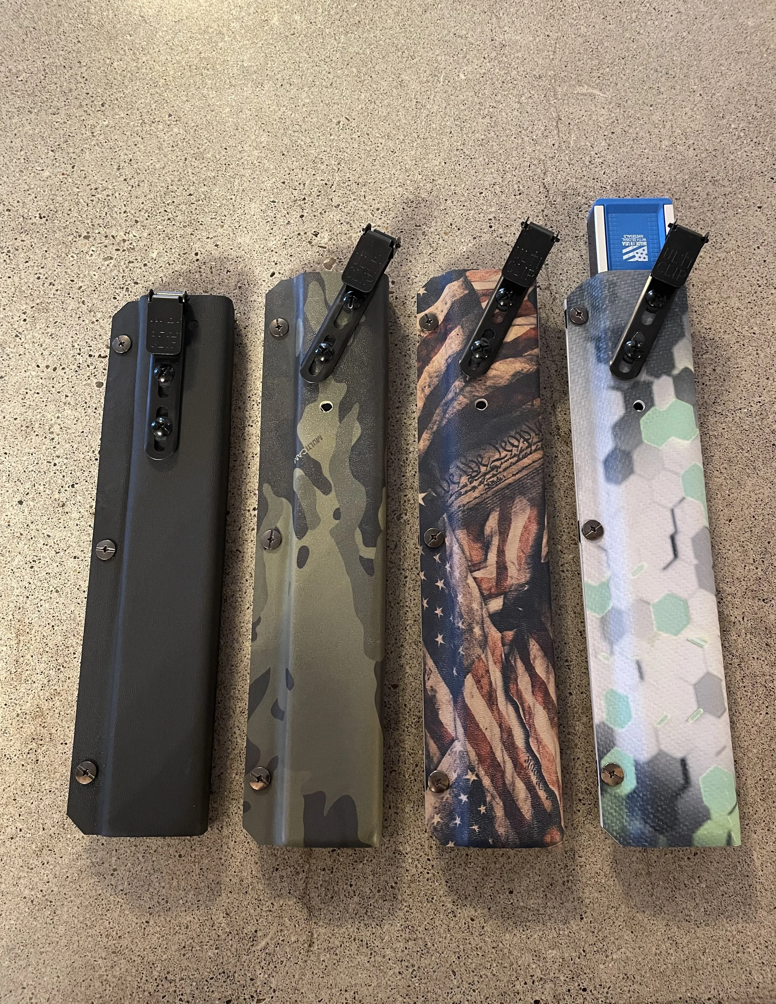 Level Lock holsters in four different designs; Black, Green Camo, American Flag, and Green pattern.