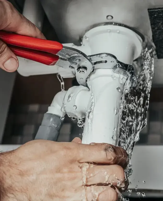 plumber making an emergency repair on a leaking pipe in snohomish