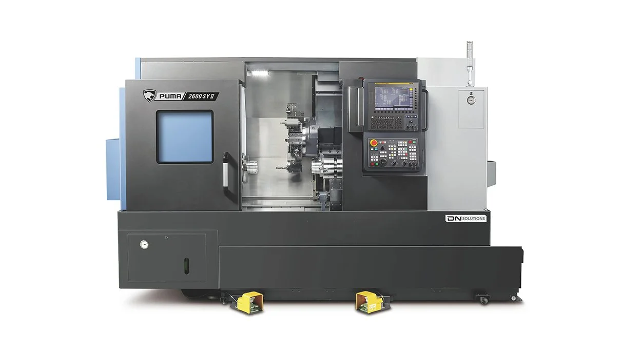 A CNC machining center with a control panel and enclosed working area, branded Puma 2600 SYD.