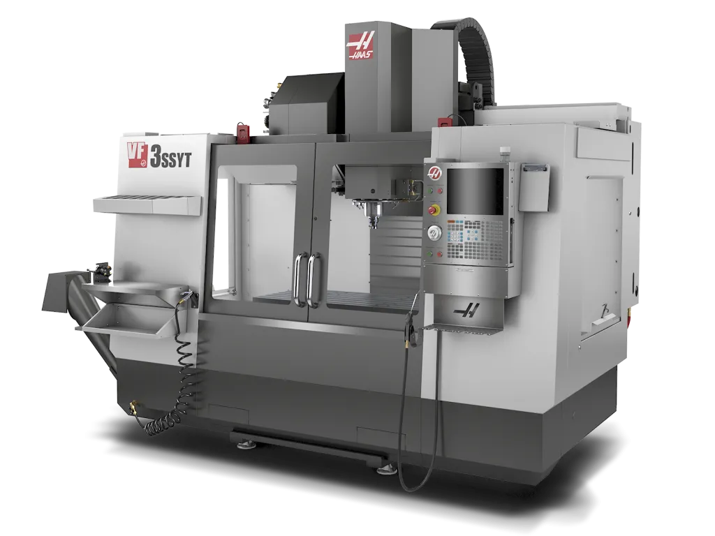 A Haas VF 3SSYT CNC vertical machining center in gray and white with a control panel, enclosed within a protective casing, and a tool clearance area.