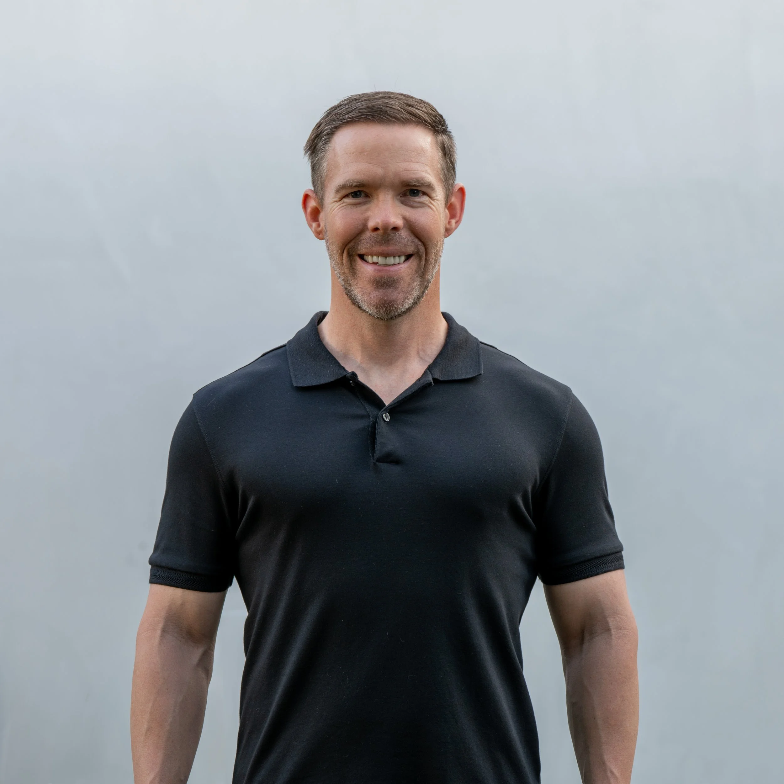 Matt Dalton, transformation coach, wearing a black polo against a clean neutral background.