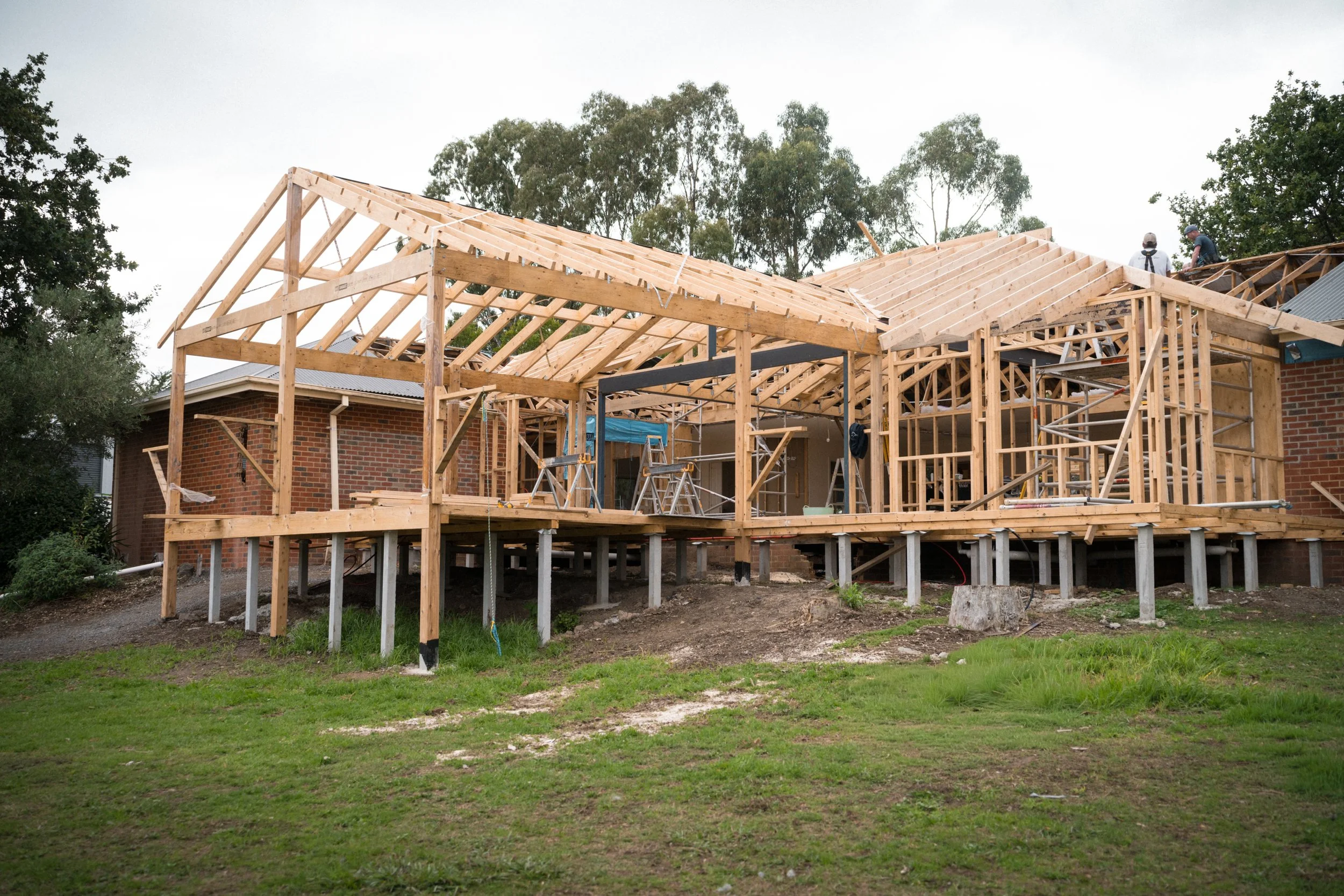 A house under construction with exposed wooden framing and scaffolding, located in a suburban in Yarra Valley built by Leisure Built