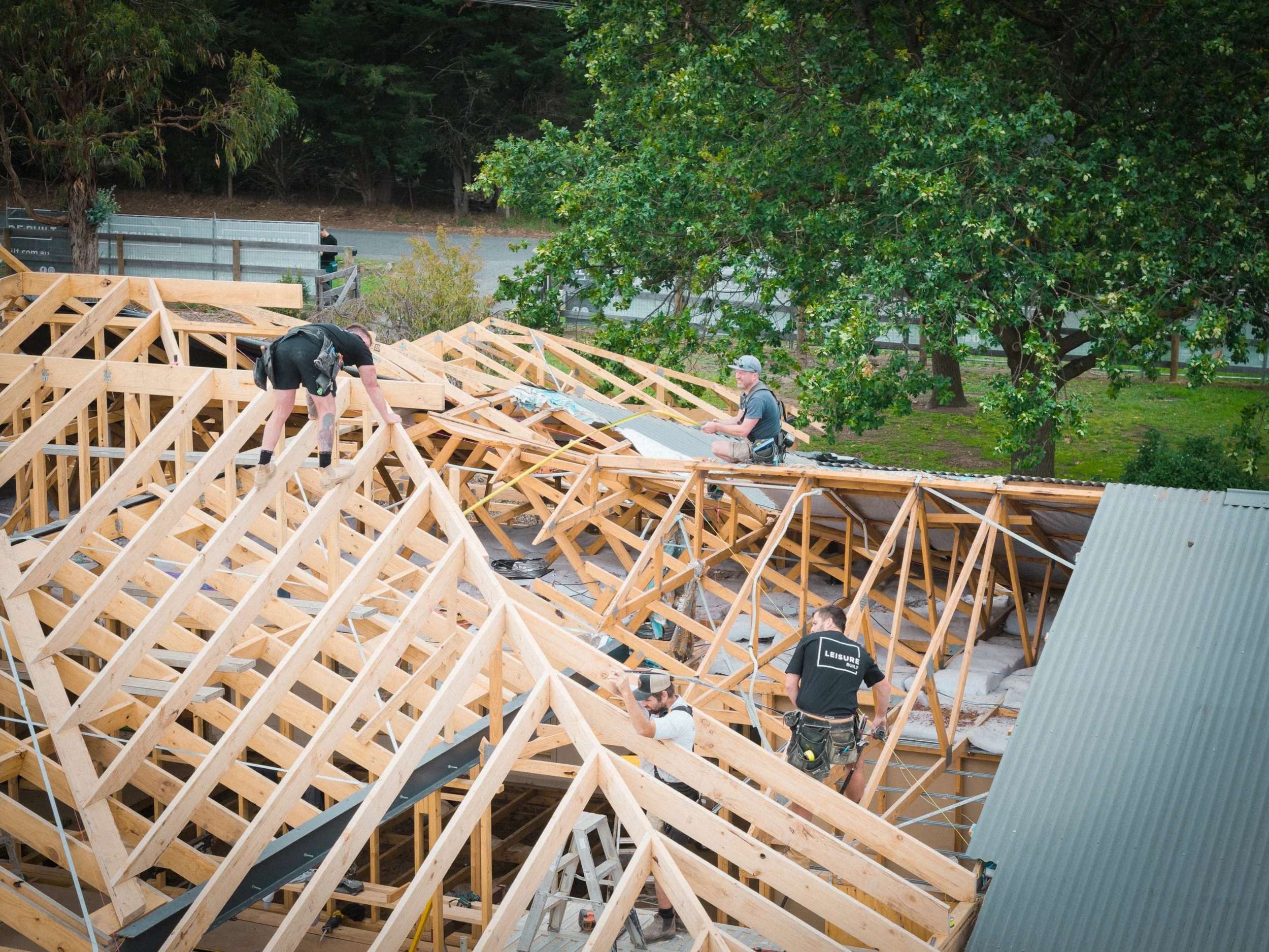 Leisure Built team building a wooden roof structure outdoors