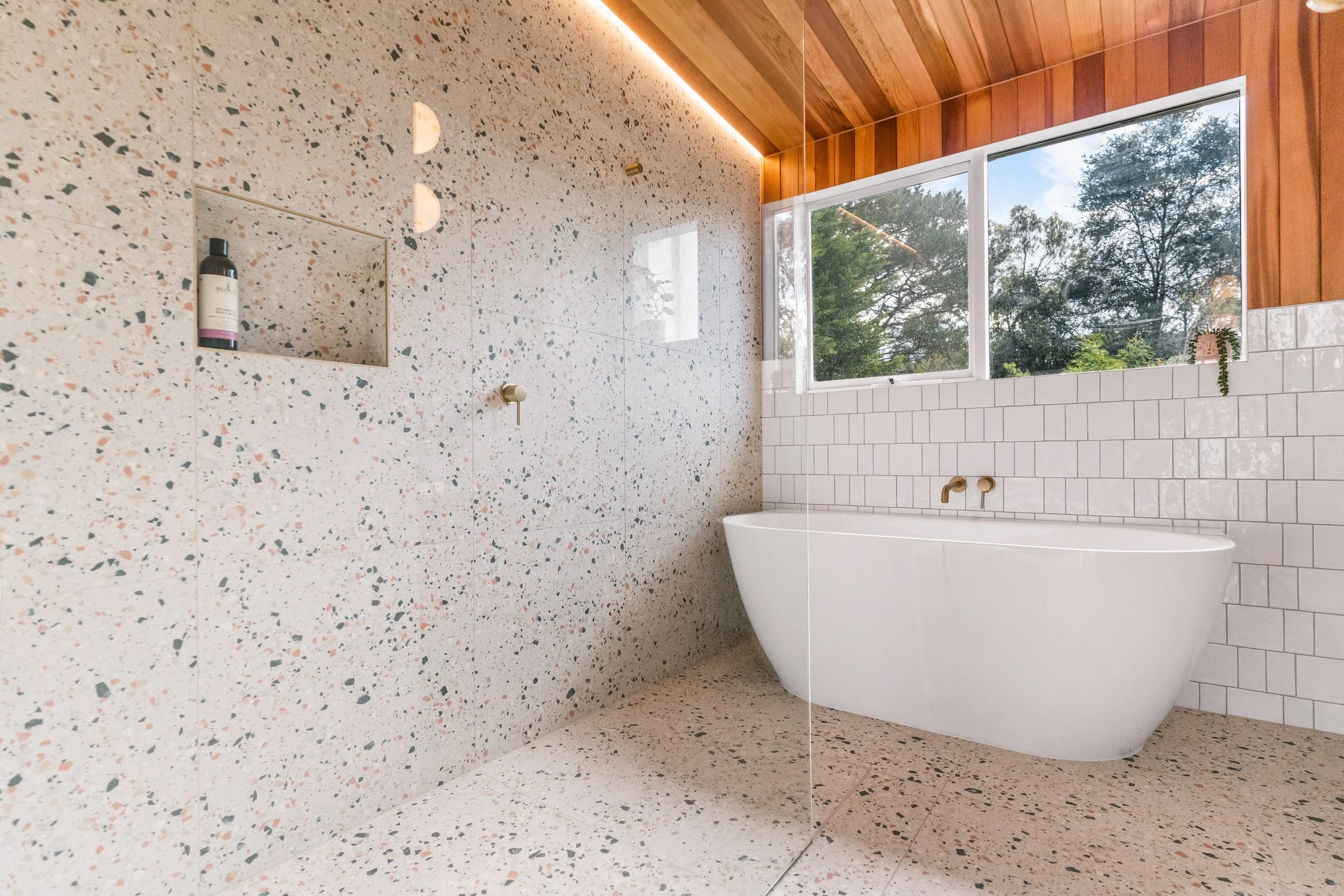 Modern bathroom with terrazzo floors and walls, large window in Yarra Valley built by Leisure Built